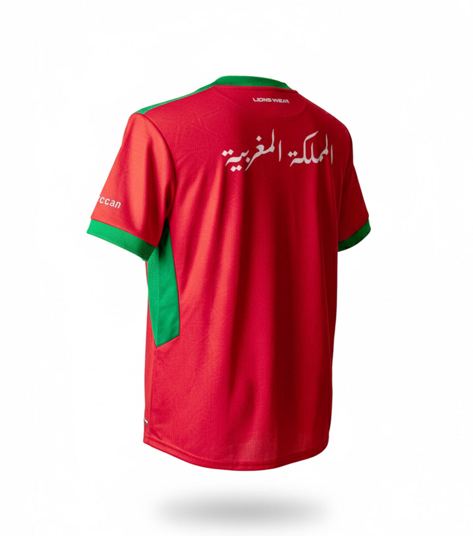 Back view of the Lions Wear Red Flow red and green football jersey with Arabic text ‘Kingdom of Morocco’ — Moroccan supporter apparel for CAN 2025.